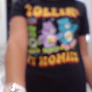 Super cute roller skating Care Bears shirt. Black with fun, and vibrant colors.